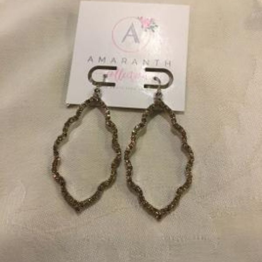 Sparkly bronze colored pierced earrings.